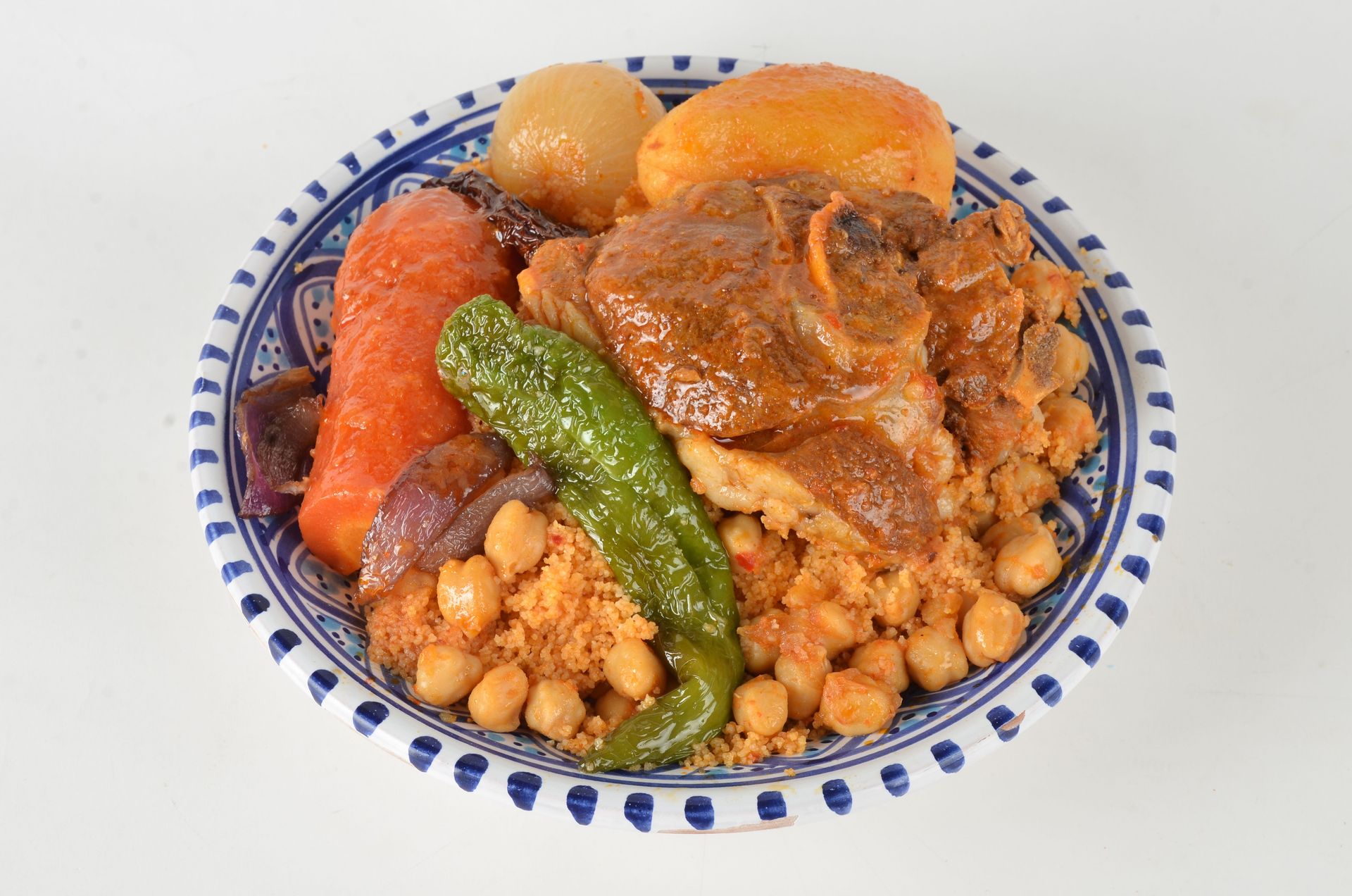 A vibrant plate of Moroccan couscous featuring tender lamb, vegetables, and chickpeas.